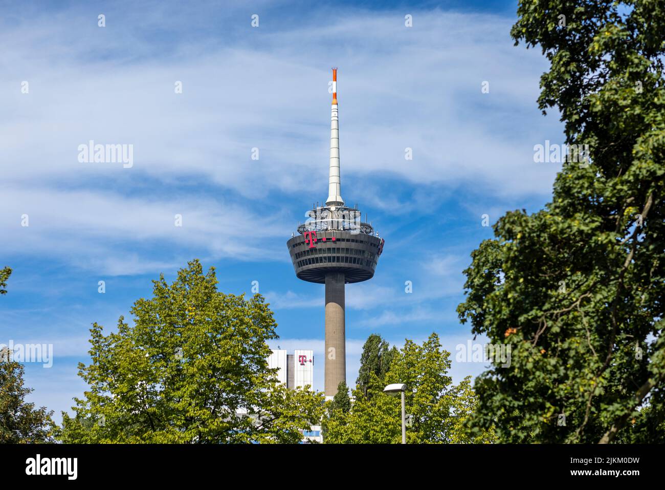 Tall communication tower rising high above Cologne urban skyline Stock Photo