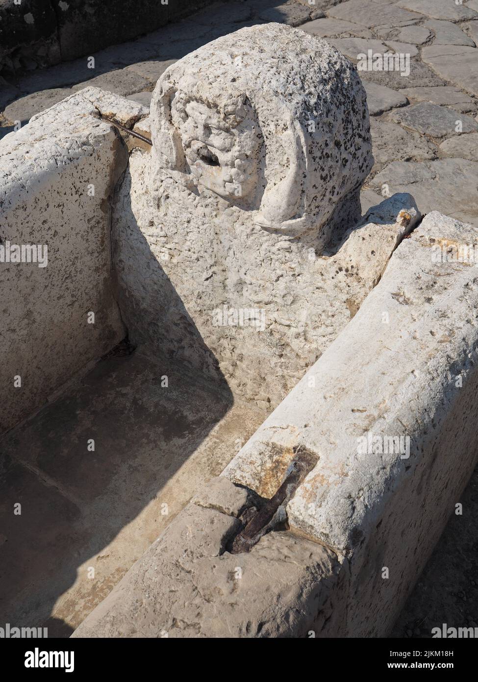 Roman marble public water fountain. These were filled a couple of times a day using a lead pipe and aquaduct system. Stock Photo