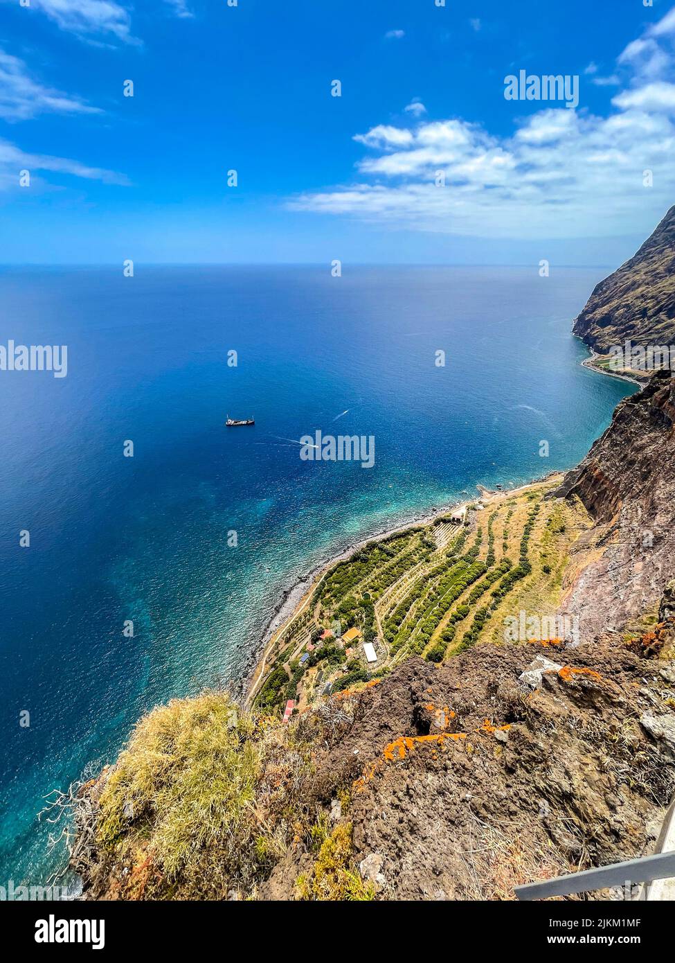 An aerial view of a mountain landscape and the coast under a clear sky ...