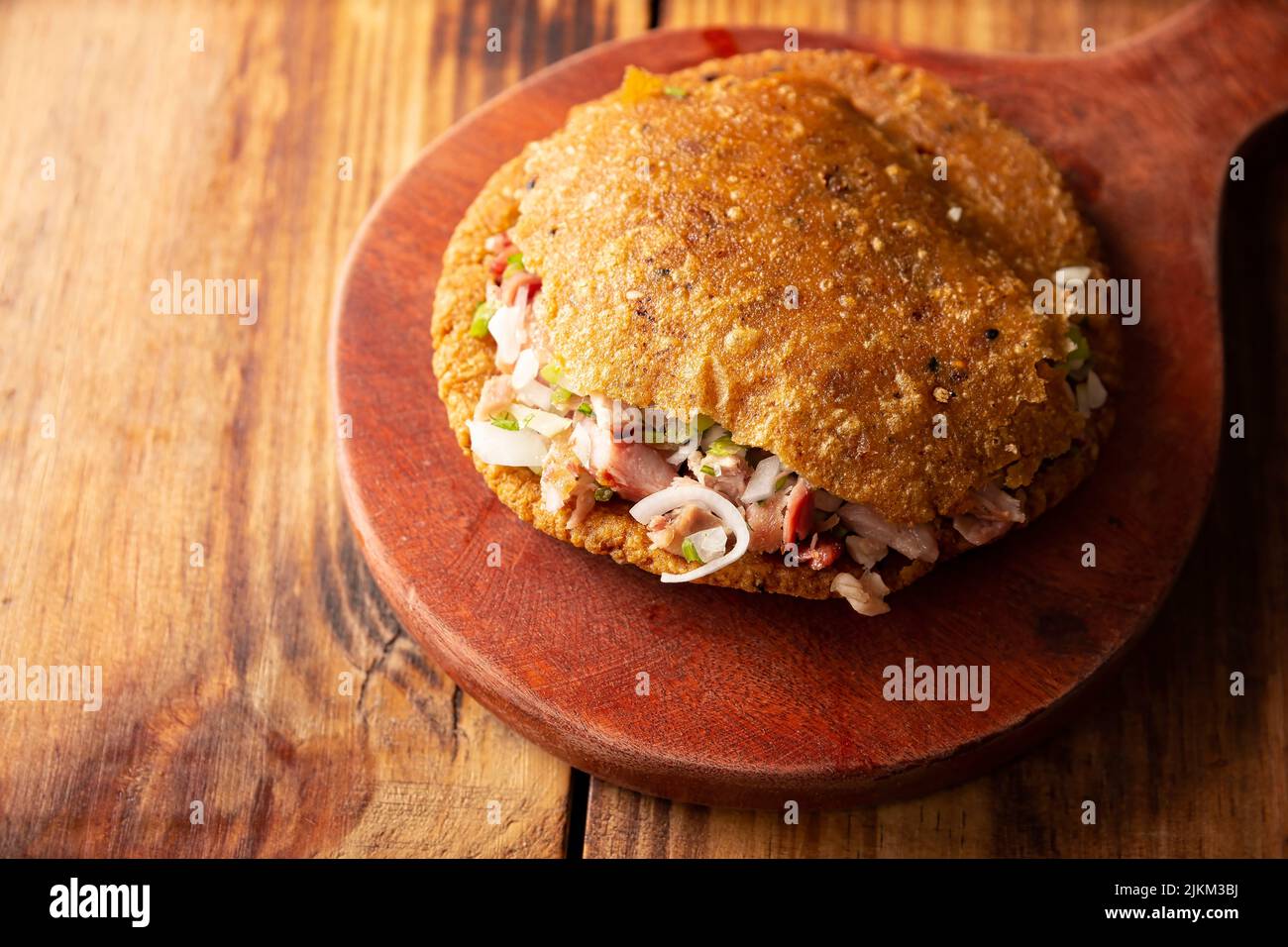 Gordita de Carnitas. Cornmeal dough stuffed with deep fried pork