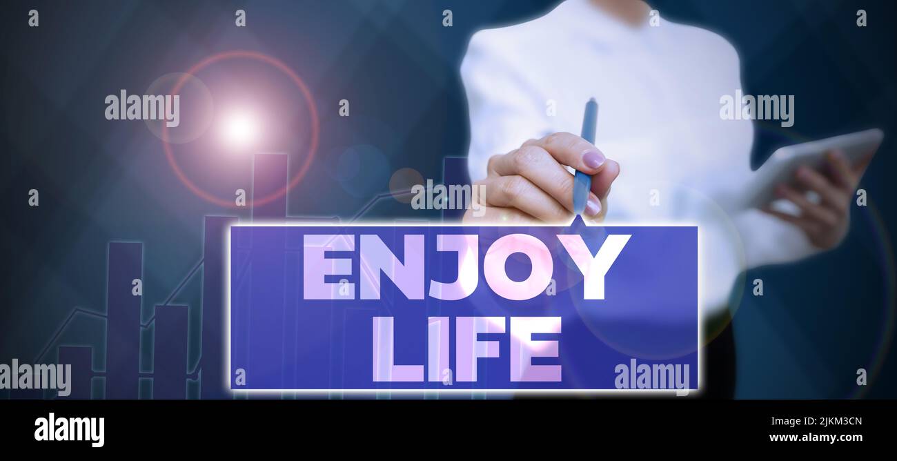 Text sign showing Enjoy Life. Conceptual photo Any thing, place,food or person, that makes you relax and happy Businessman in suit holding tablet Stock Photo