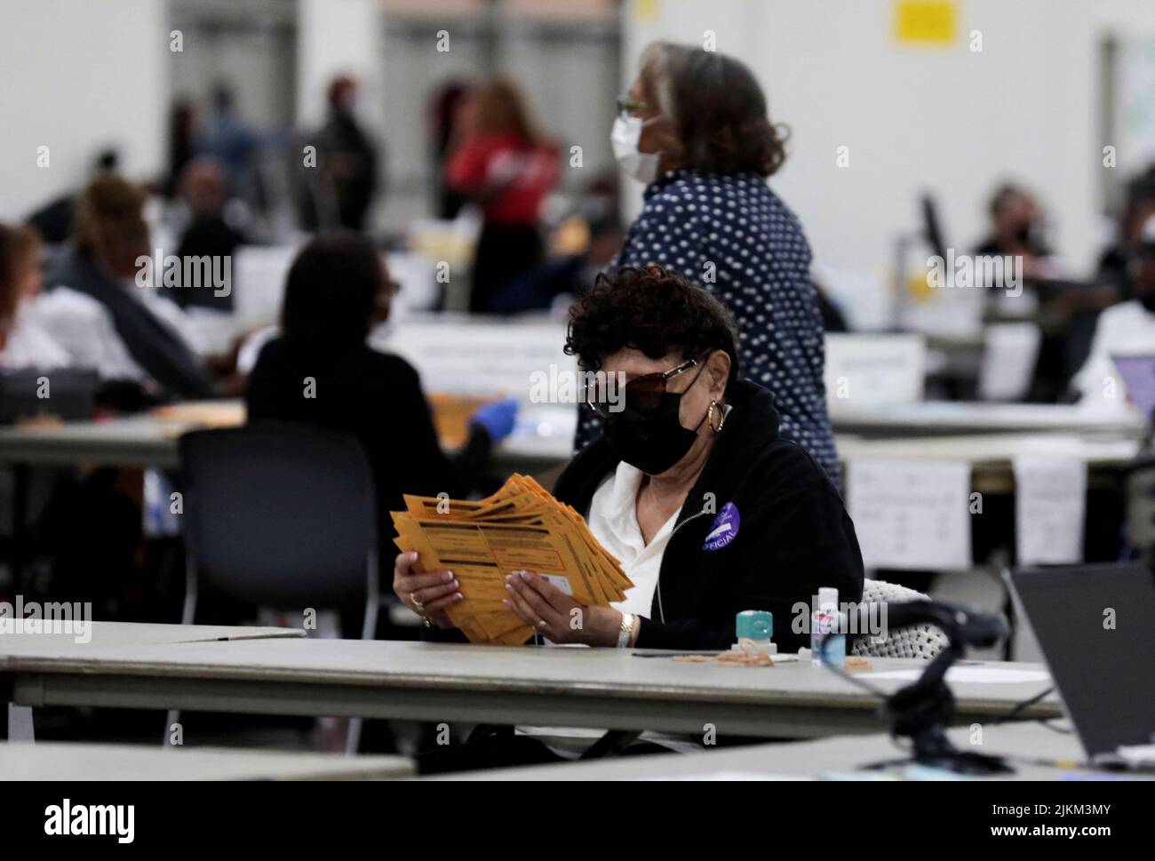 An election worker prepares absentee ballots for counting at Huntington Place during the primary election in Detroit, Michigan, U.S. August 2, 2022.  REUTERS/Rebecca Cook Stock Photo