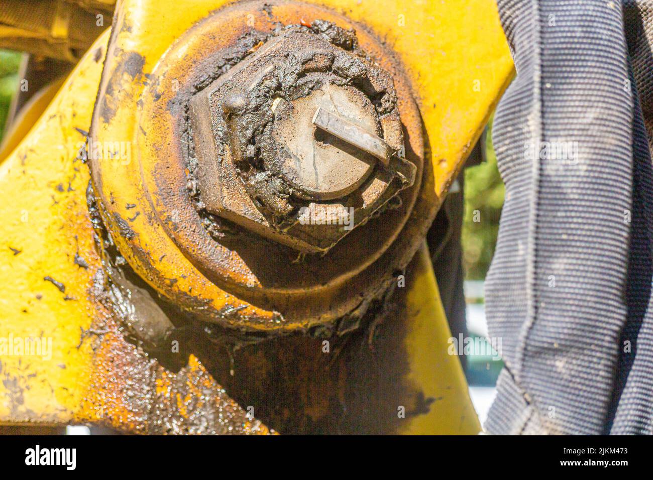 close up of a yellow joint on the arm of a shovel excavator with a lot of grease Stock Photo