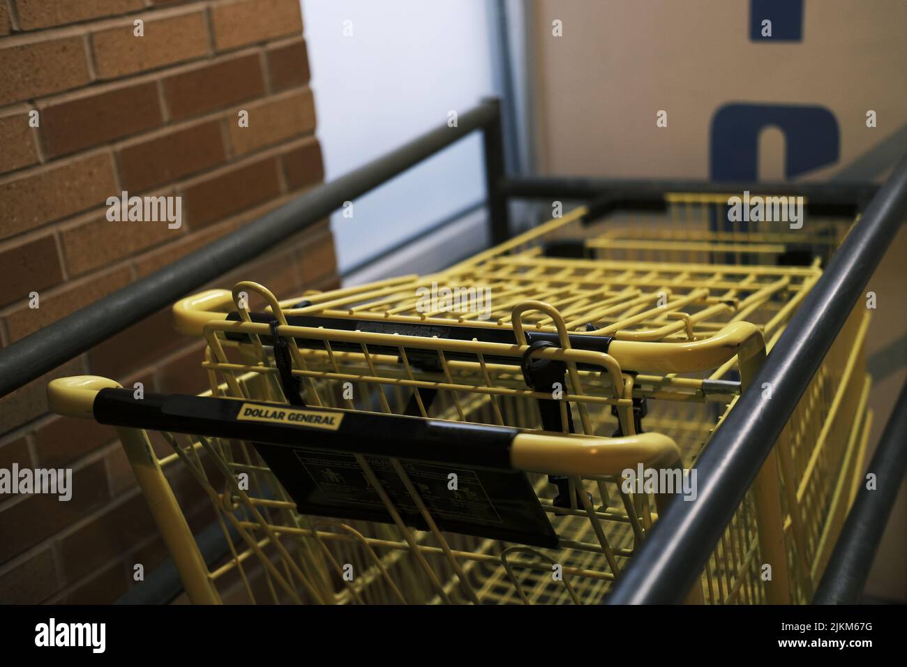 A closeup of yellow shopping supermarket carts inside the building ...