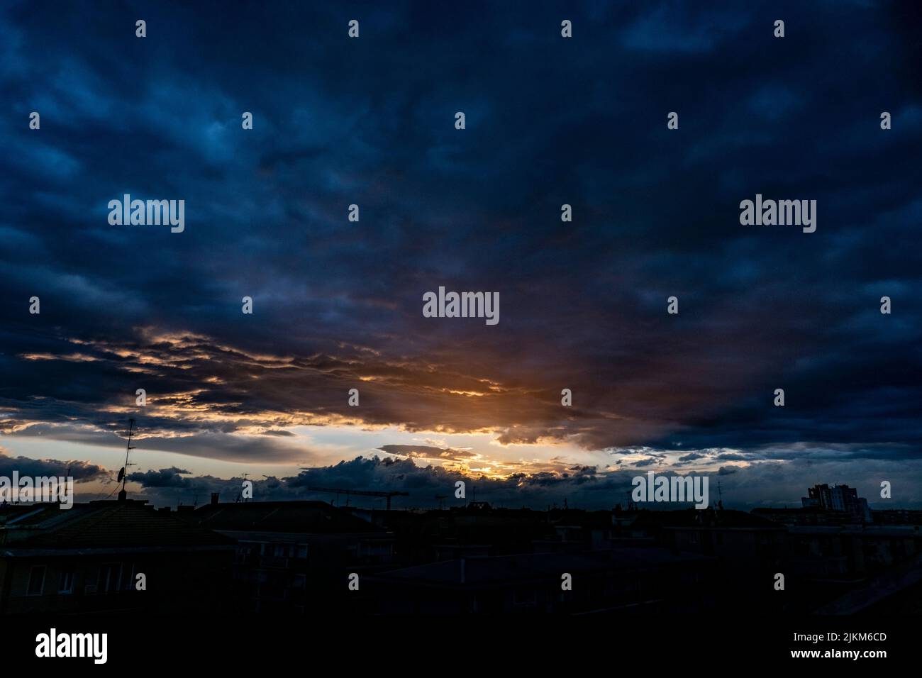 A dramatic view of dark clouds in the colorful sky during sunset Stock ...