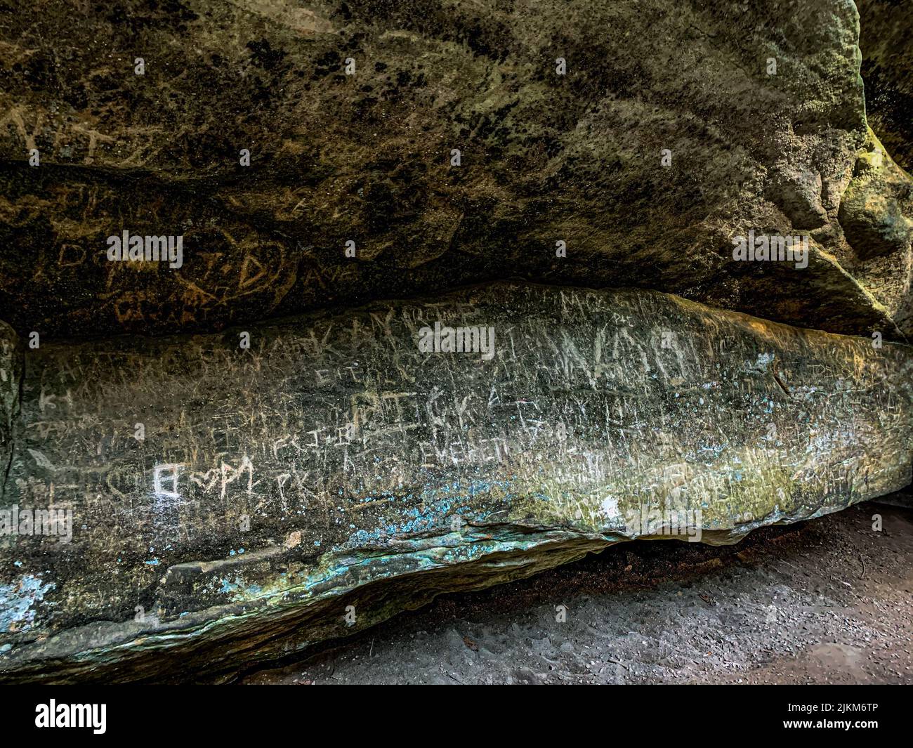 A closeup of the piece of a big rock with writings on it Stock Photo