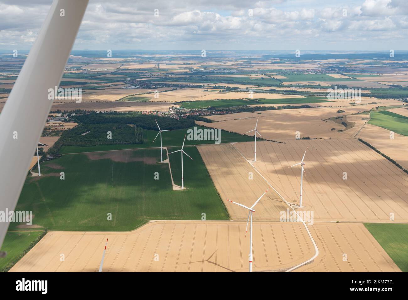 Erfurt, Thuringia, Germany, July 11, 2022 Wind energy stations on a meadow seen from a small plane Stock Photo