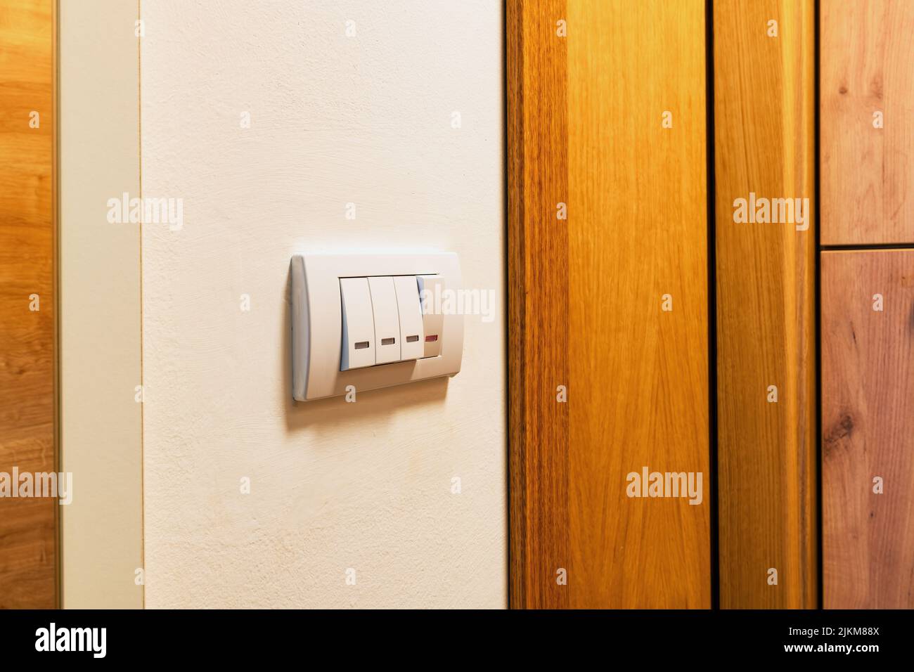Bathroom switches with light indicators at home apartment wall, selective focus Stock Photo