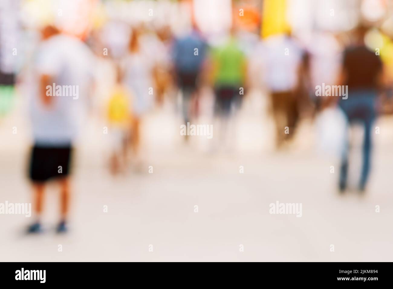 Crowd of anonymous people on the street in summer, tourist pedestrians walking in the city, selective focus with copy space Stock Photo