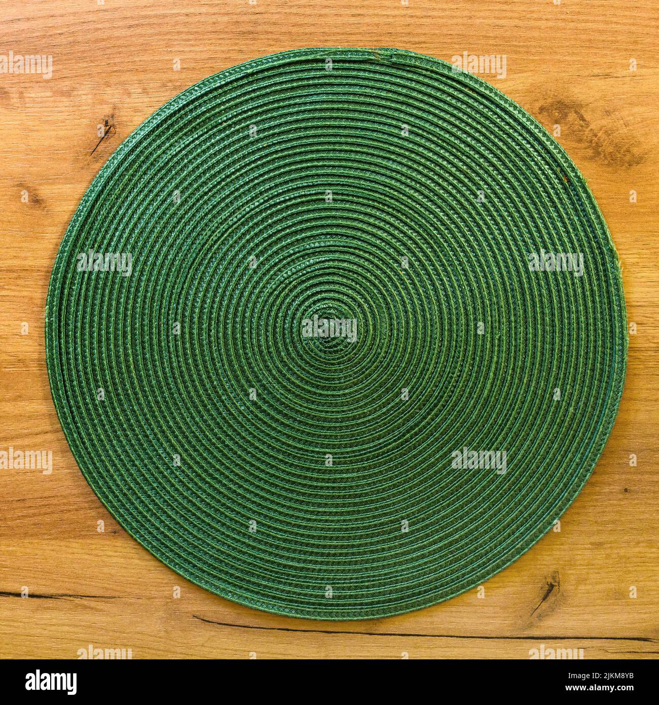 Texture of green plastic woven placemat on dining table, top view Stock Photo