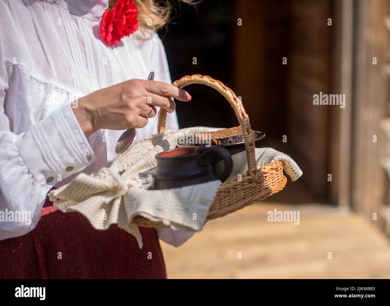 A selective of female hands holding a basket with traditional goods for a wedding ceremony Stock Photo