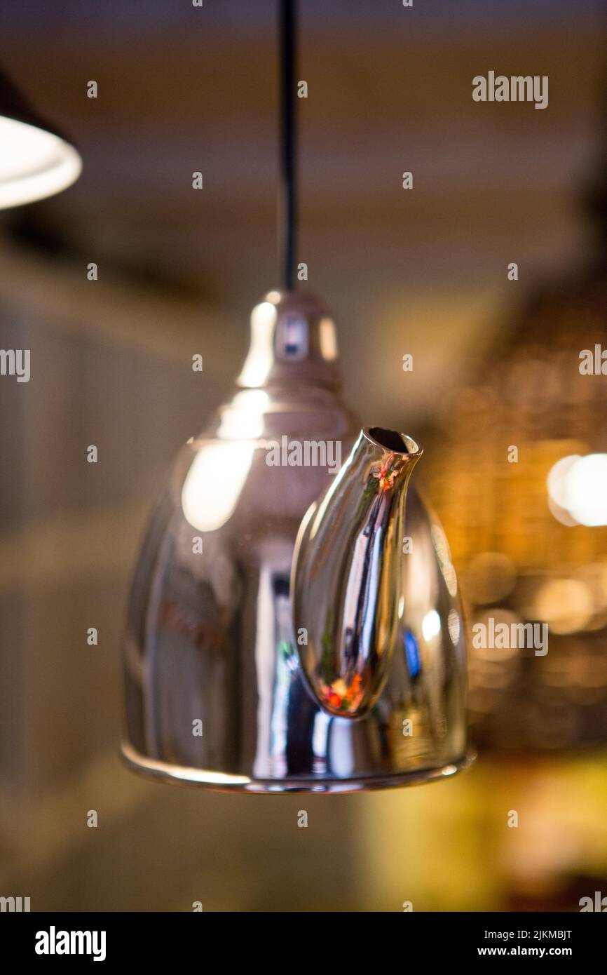 Metal kettle for welding hanging from the ceiling as an element of interior design Stock Photo