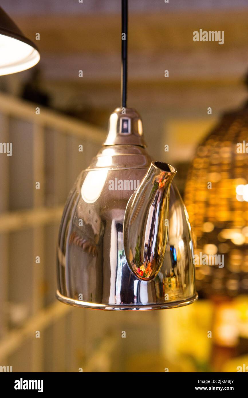 Metal kettle for welding hanging from the ceiling as an element of interior design Stock Photo