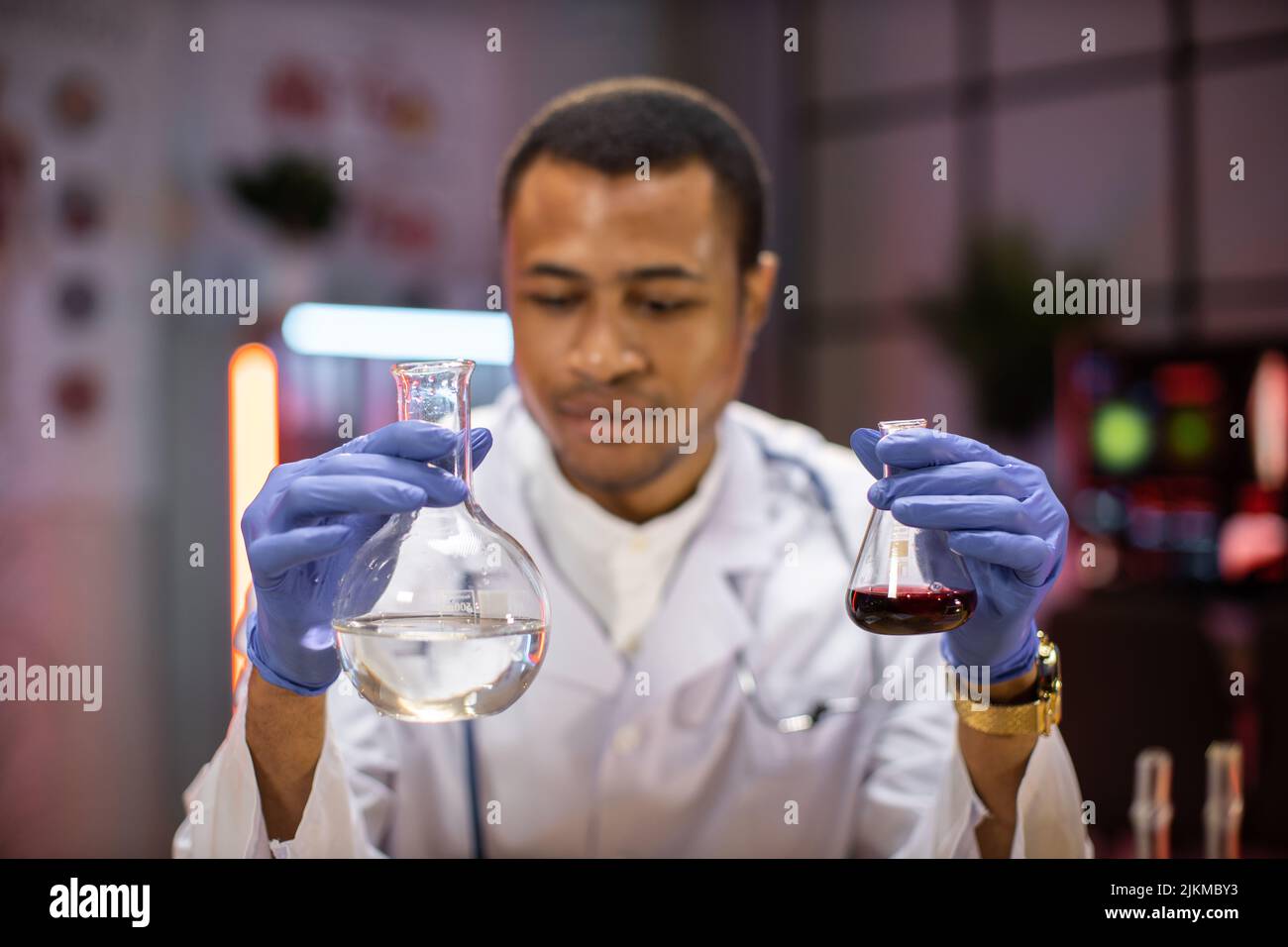Male scientist working in modern lab. Doctor making microbiology research. Laboratory tools: microscope, test tubes, equipment. Coronavirus covid-19, bacteriology, virology, dna and health car Stock Photo