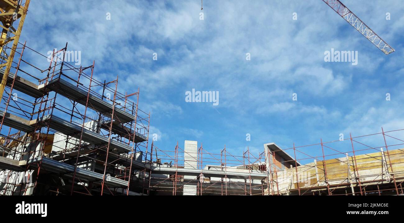 A building under construction with scaffolding on a blue sky Stock ...