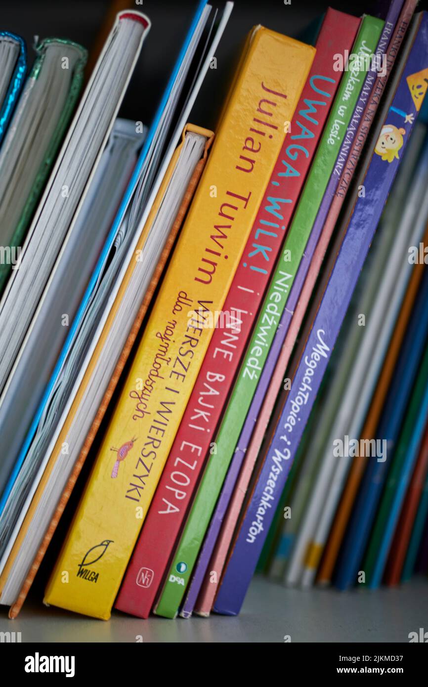 A row of colorful Polish story books for children on a shelf in Poznan, Poland Stock Photo