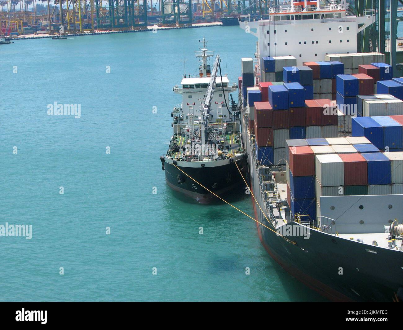 Bunkering tanker container ship in port Stock Photo