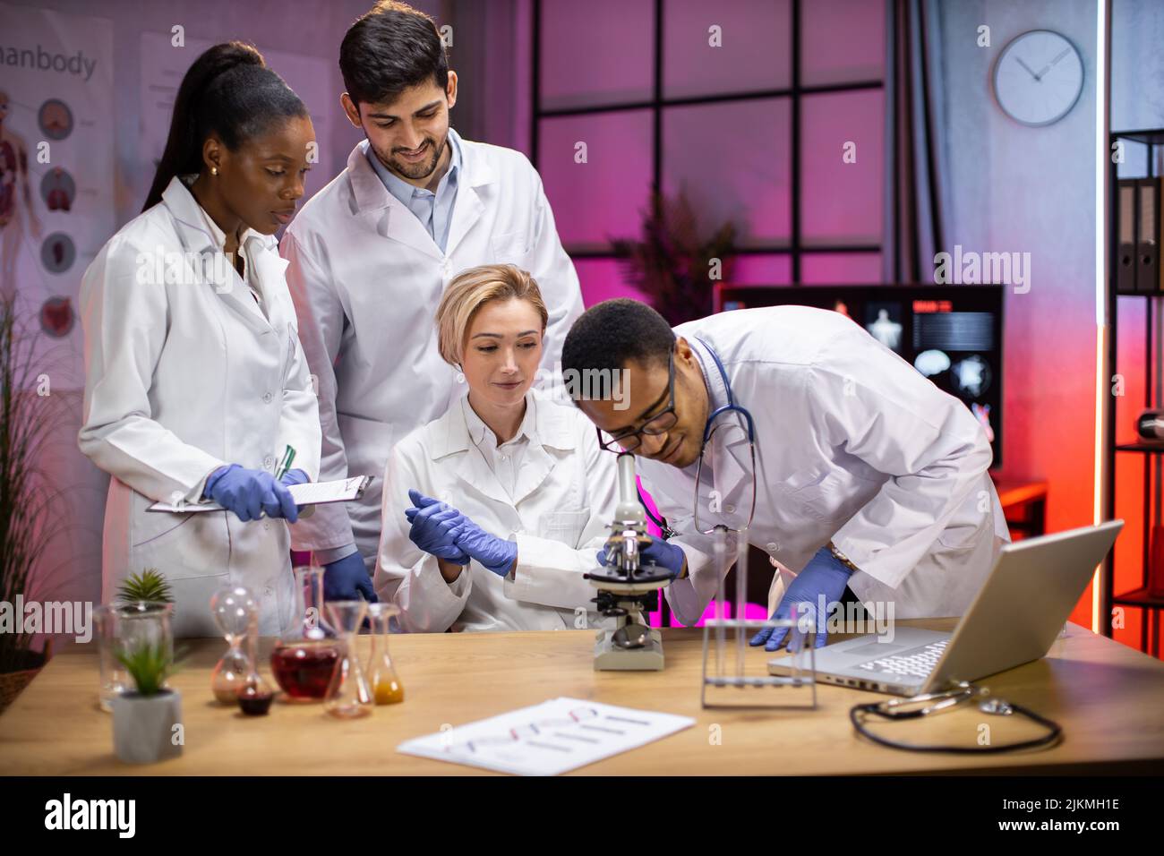 View of modern university research laboratory with multiracial team of