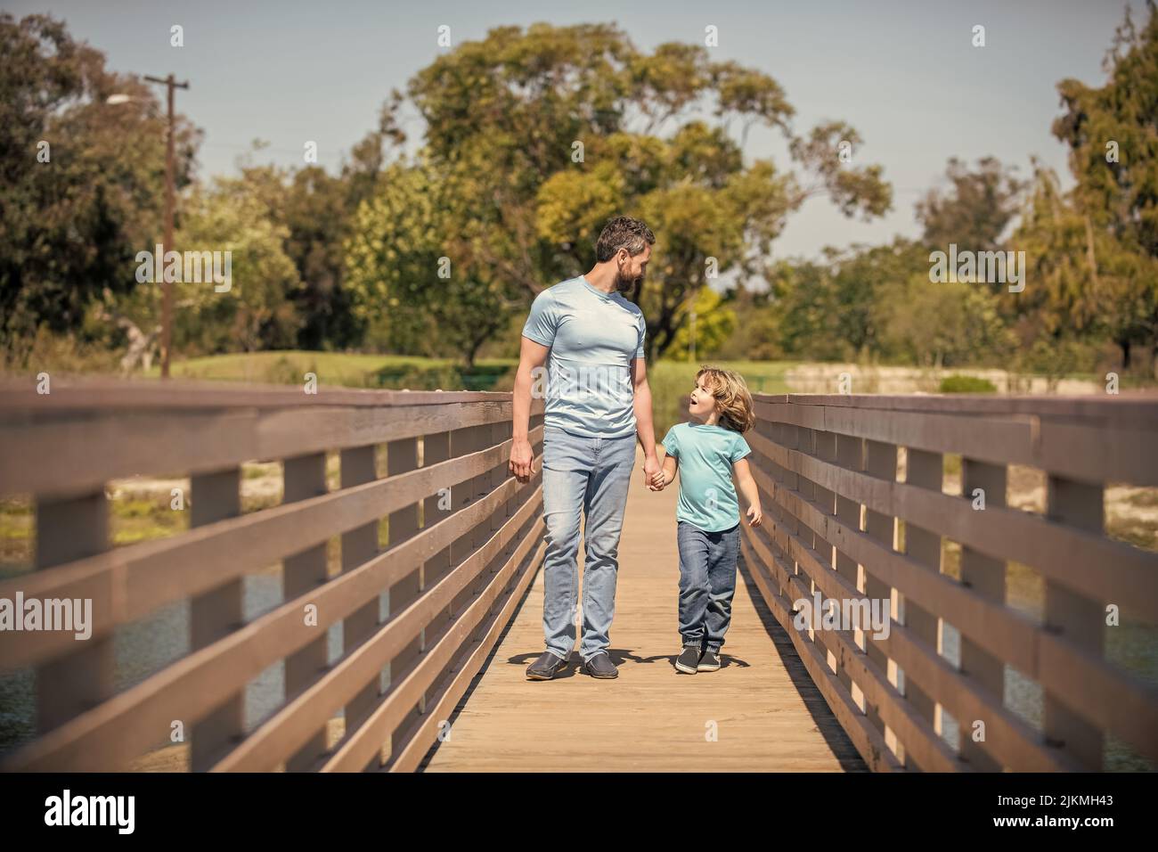smiling father and son walking outdoor. family value. childhood and parenthood. Stock Photo