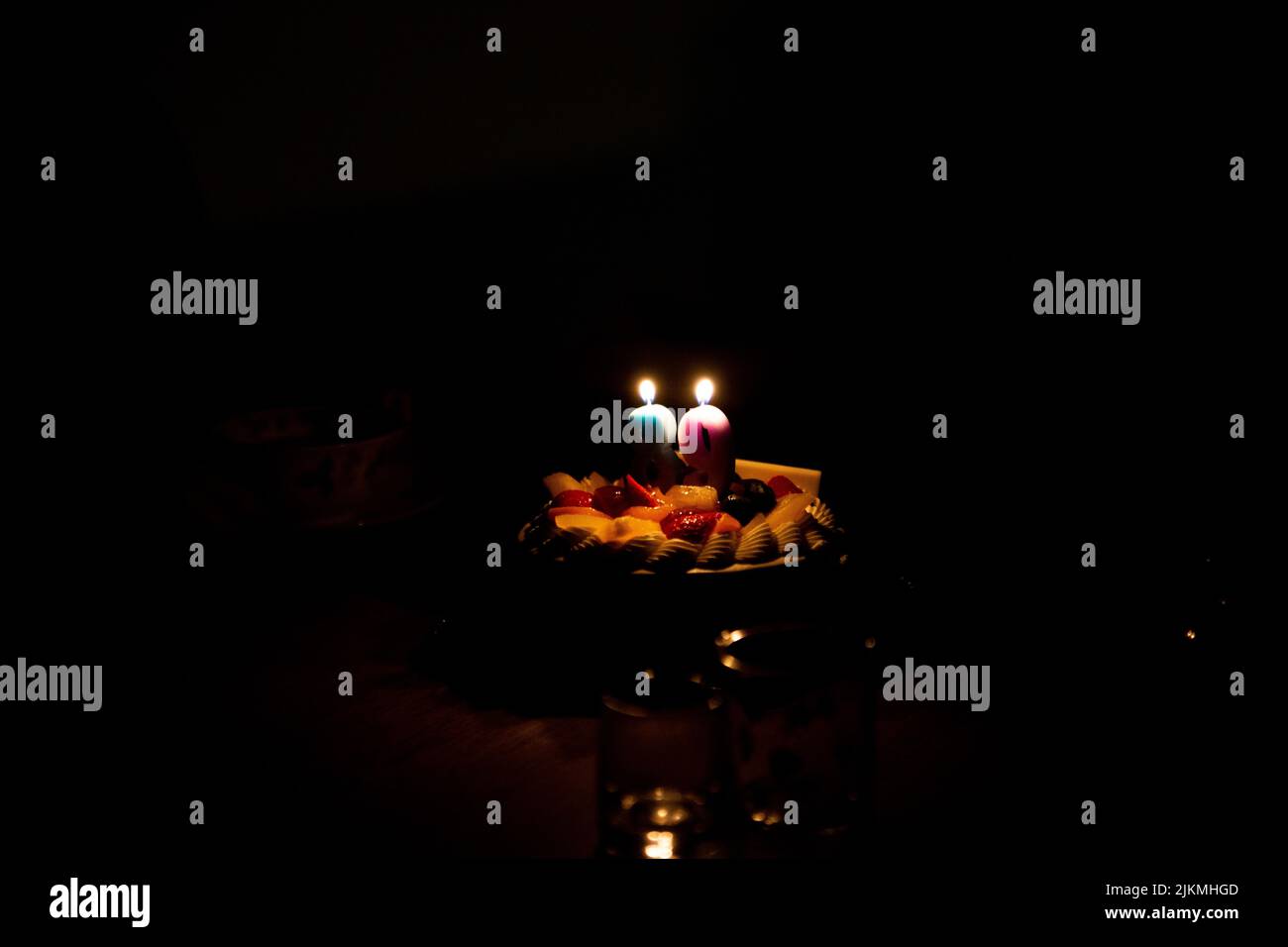 Candles in the shape of 8 and 9 are lit on the 89th Birthday Cake Stock