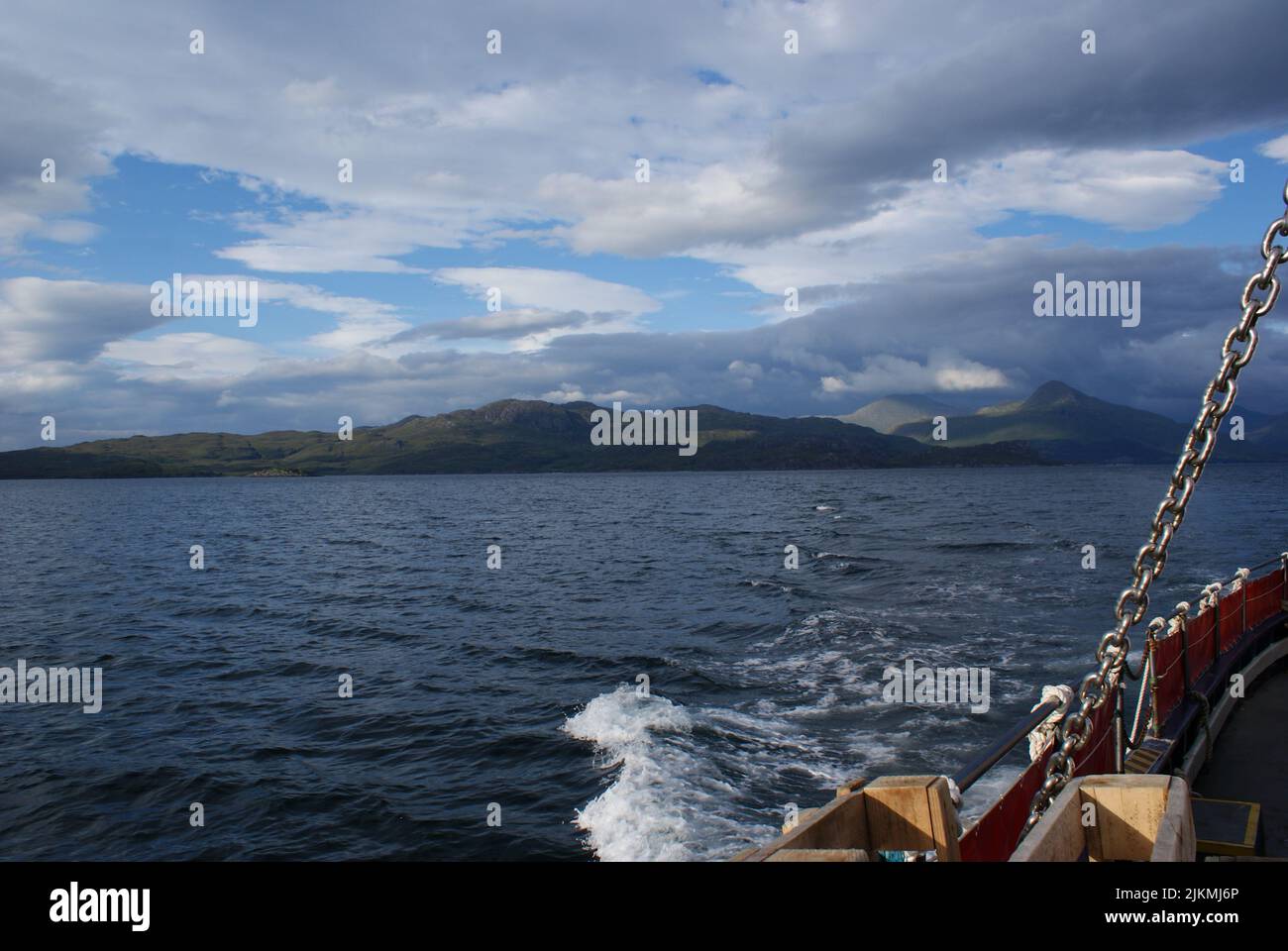 A beautiful view of waves on the sea behind a boat in Scotland Stock Photo