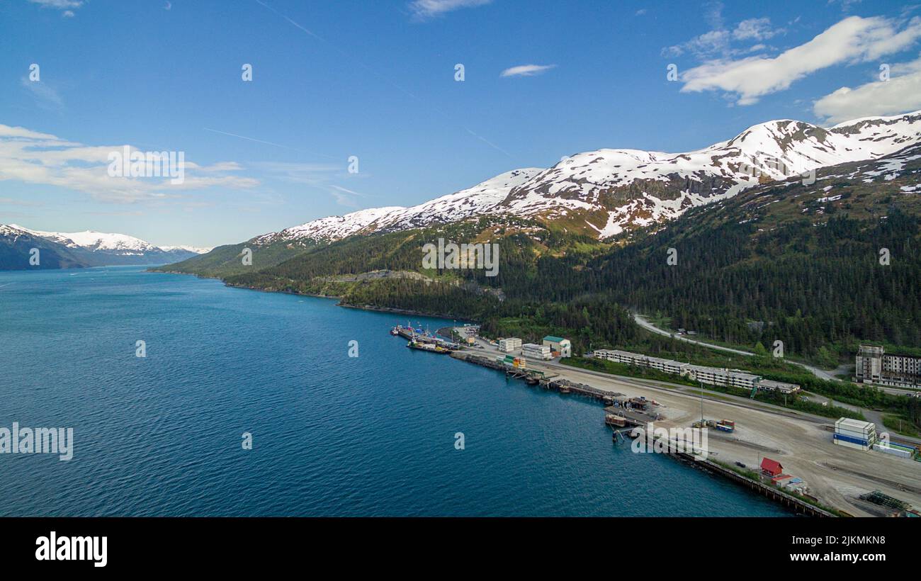 An aerial view of the harbor in Whittier, Alaska, with a cruise ship in