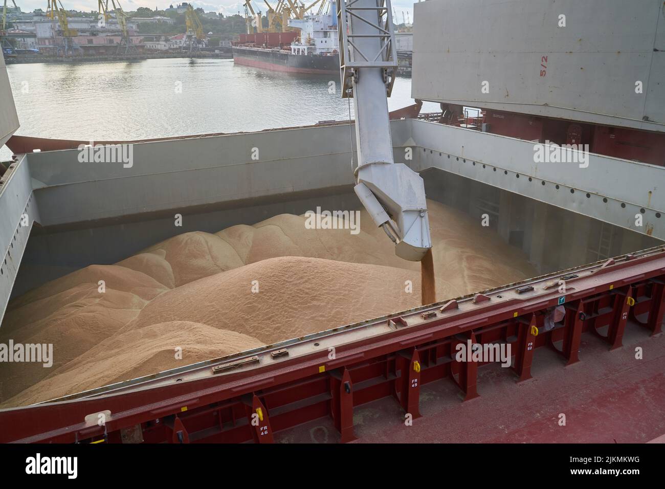 loading corn onto a bulk carrier ship in the port at the grain terminal