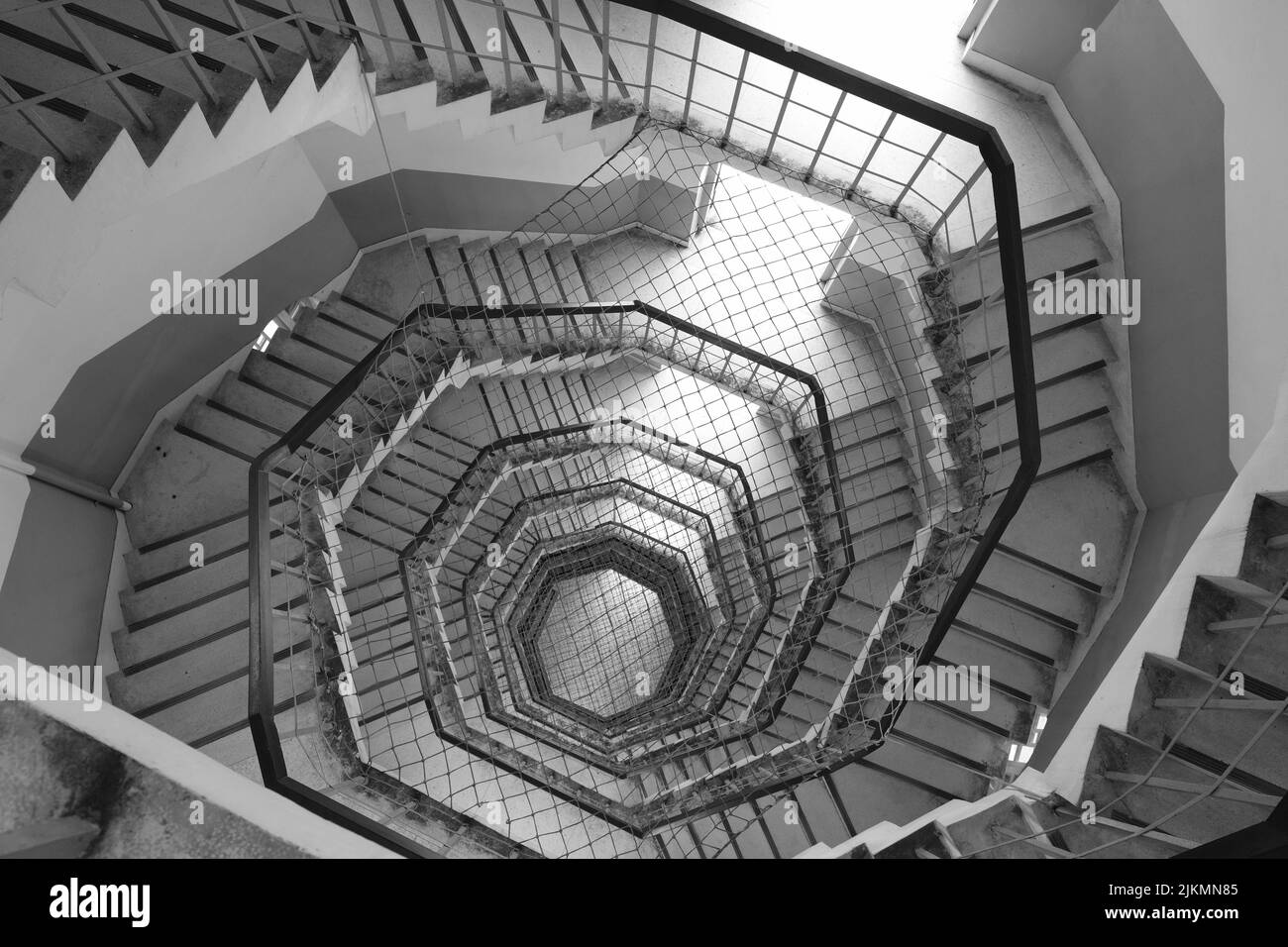 A grayscale shot of a spiral staircase. Stock Photo