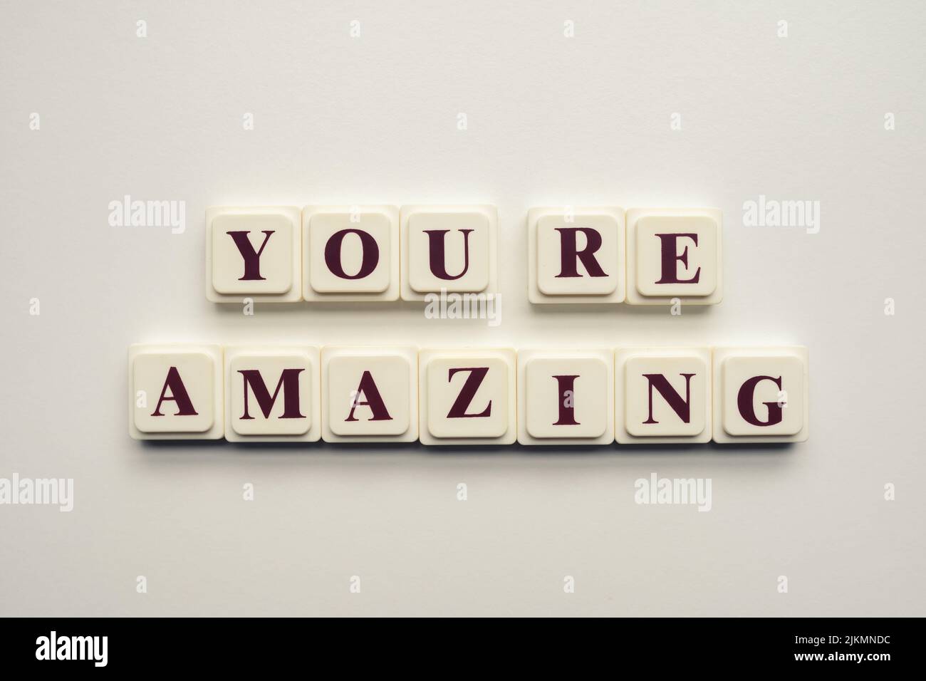 A closeup of scrabble tiles with letters spelling the message 