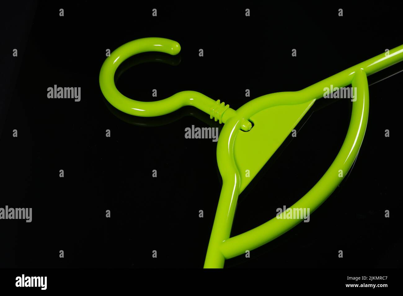 A green plastic hanger on black background Stock Photo Alamy