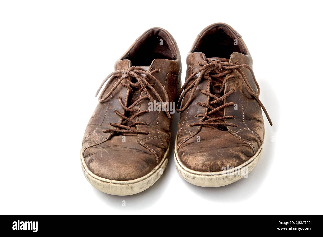 Textured worn vintage brown leather men’s boots isolated on white