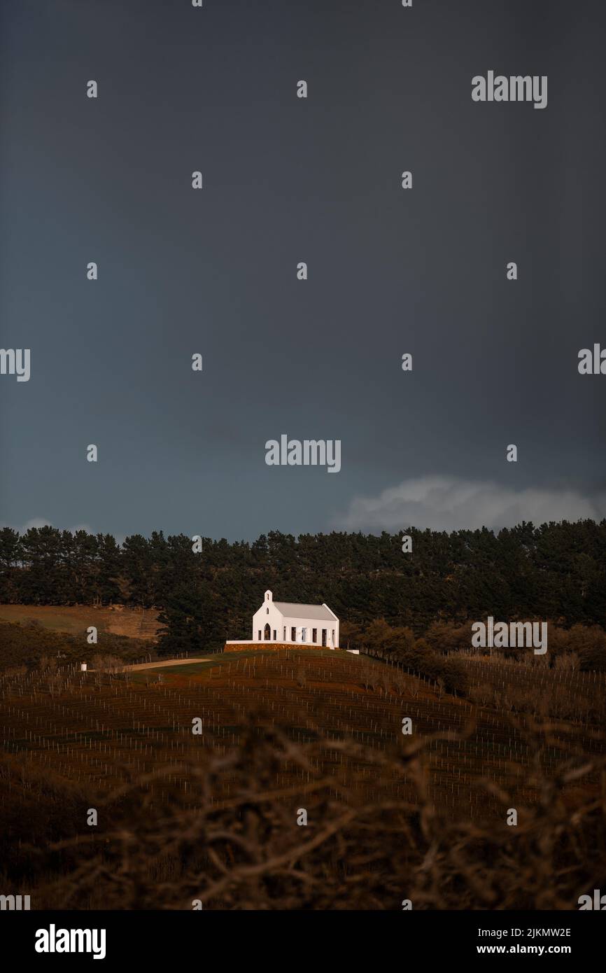 A vertical shot of a church on a hilltop under a gloomy sky in Cape ...