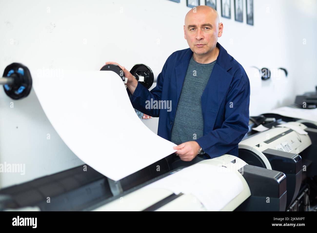 Man working in publishing facility Stock Photo