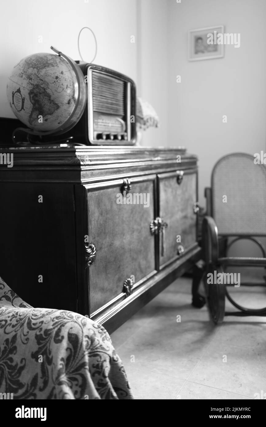 A grayscale shot of an old vintage-style furnished room Stock Photo