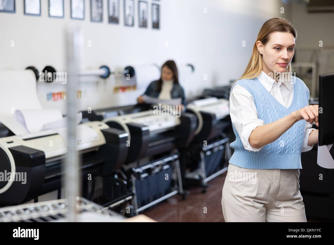 Woman working in printing office, using printer Stock Photo Alamy