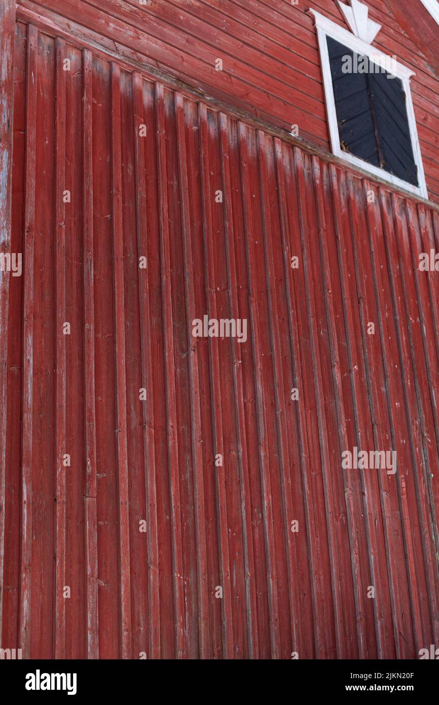A vertical shot of a red, old wall of a house Stock Photo