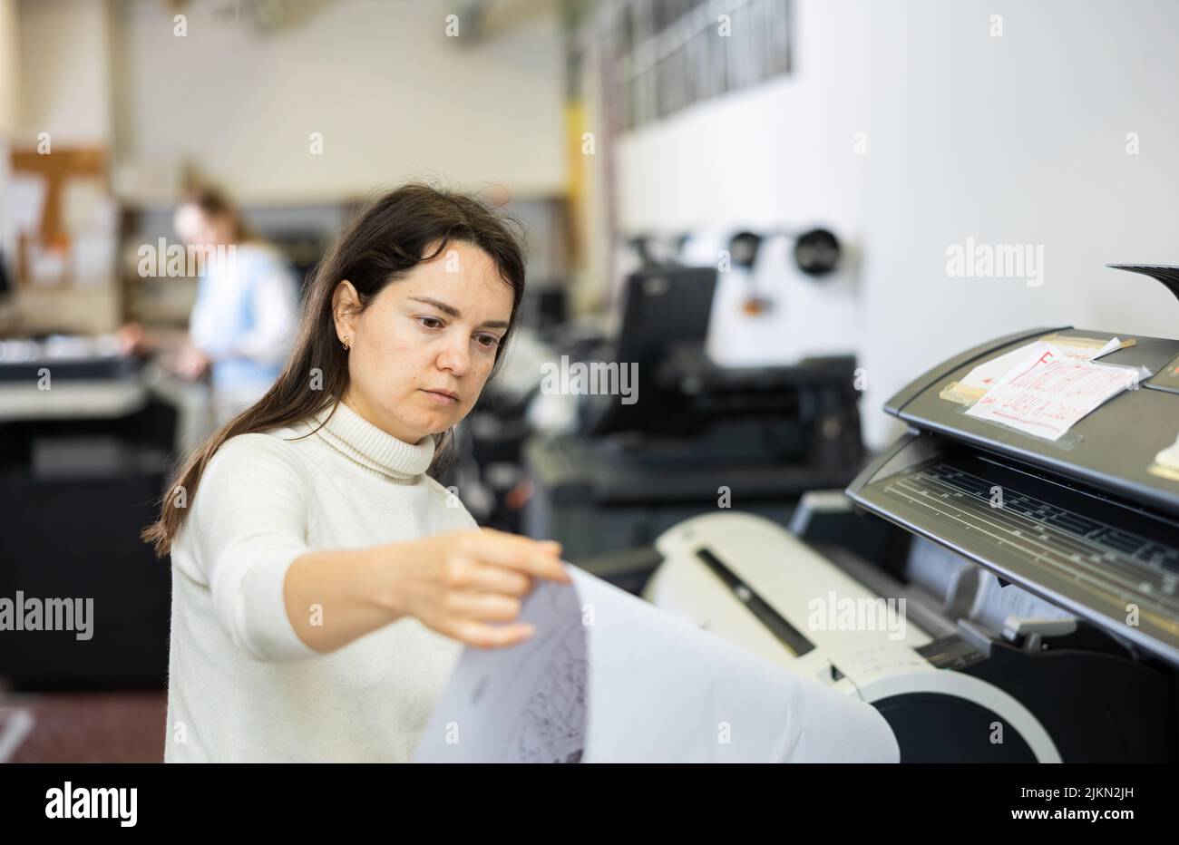 Worker in a printing and press centar check print quality Stock Photo