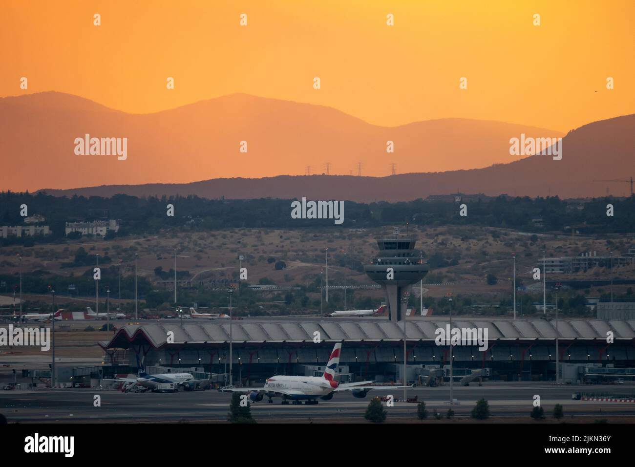 Madrid, Spain. 02nd Aug, 2022. View of Adolfo Suarez Madrid Barajas Airport at sunset during a summer storm. Rain and hail have reached the city of Madrid during a summer storm, accompanied by high temperatures during a heat wave in which 40 degrees Celsius have been exceeded during the day in some areas of the Community of Madrid. Credit: Marcos del Mazo/Alamy Live News Stock Photo
