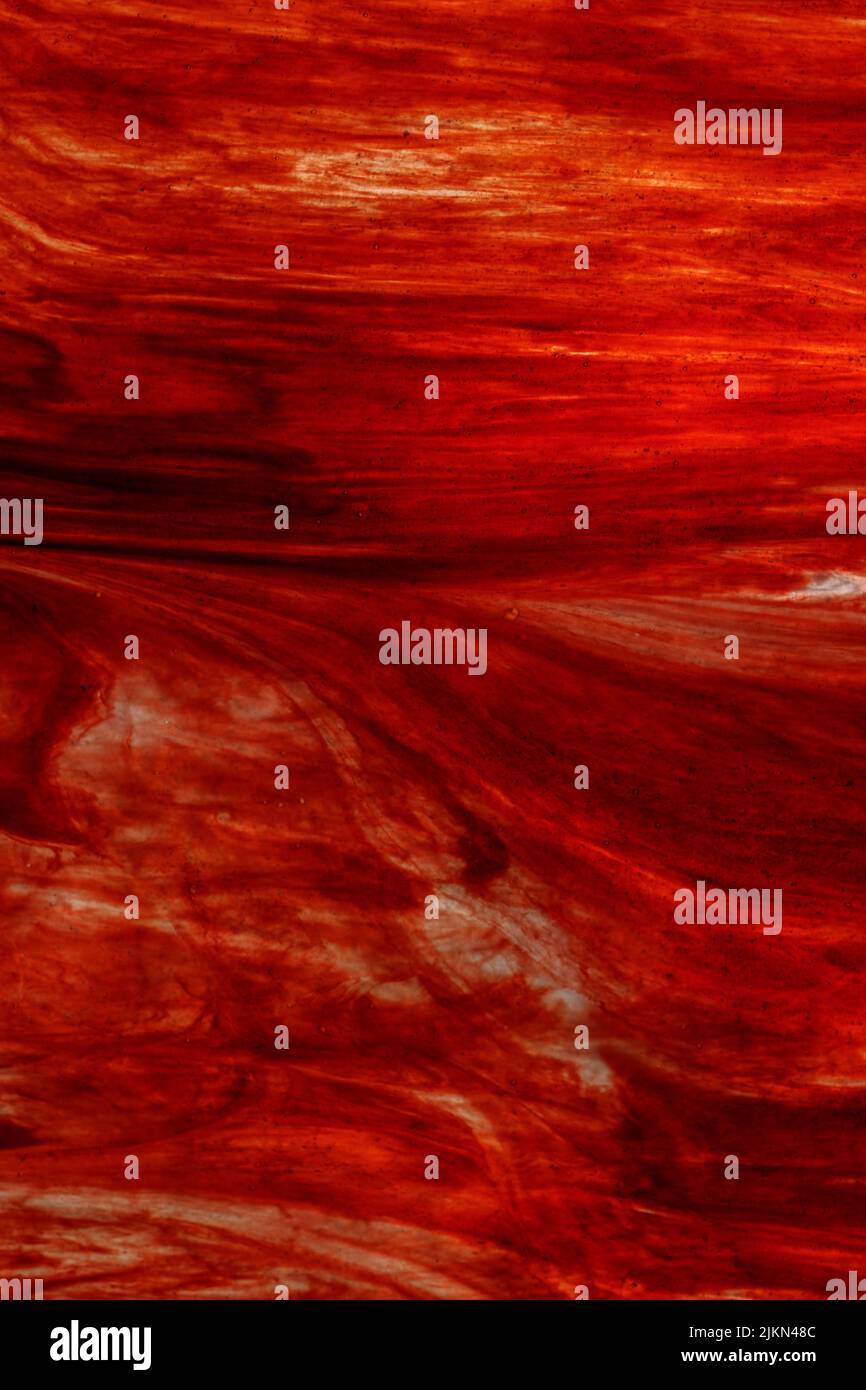 A vertical image of red and yellow backlit corrugated glass - Abstract ...