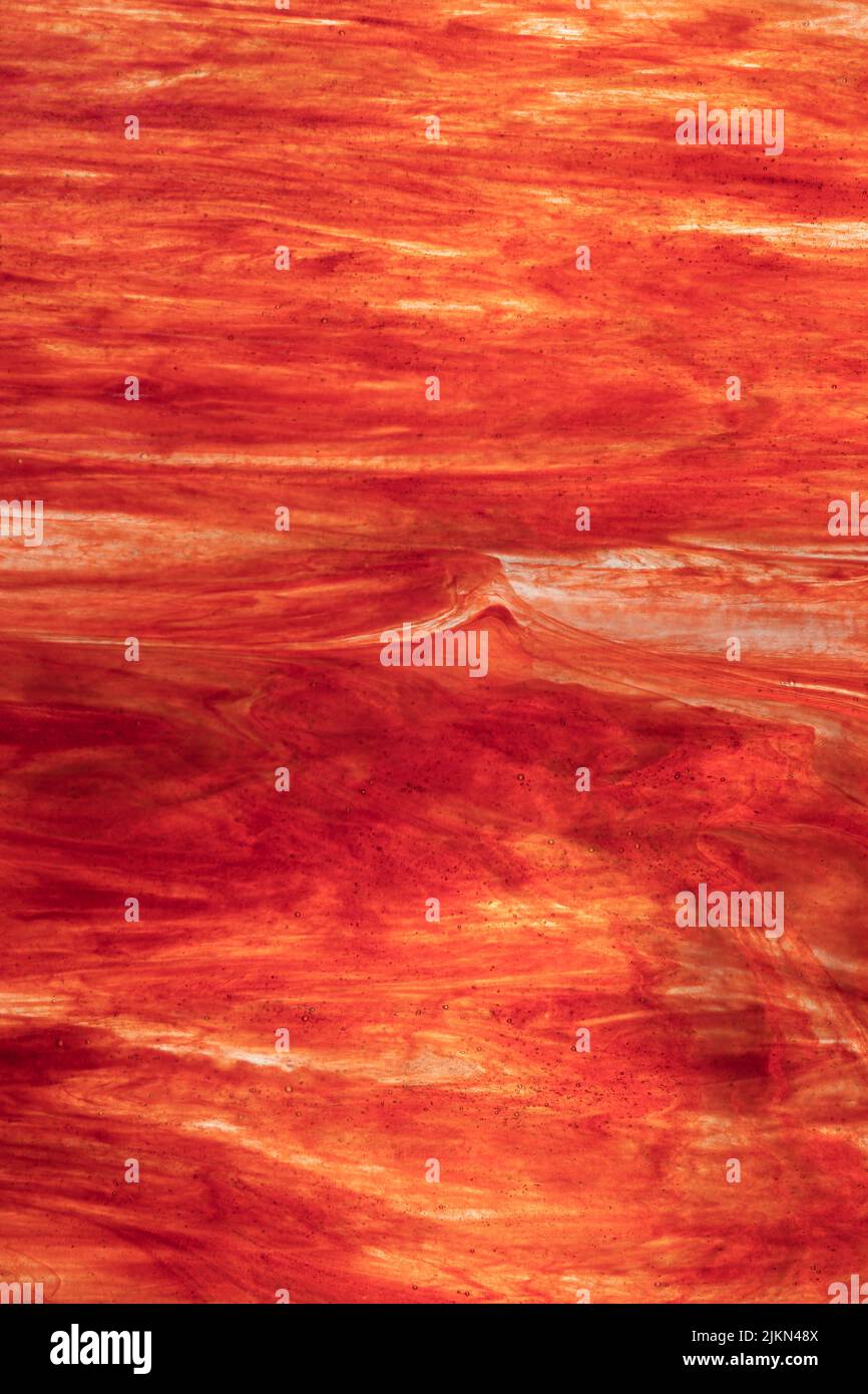 A vertical image of red and yellow backlit corrugated glass - Abstract ...