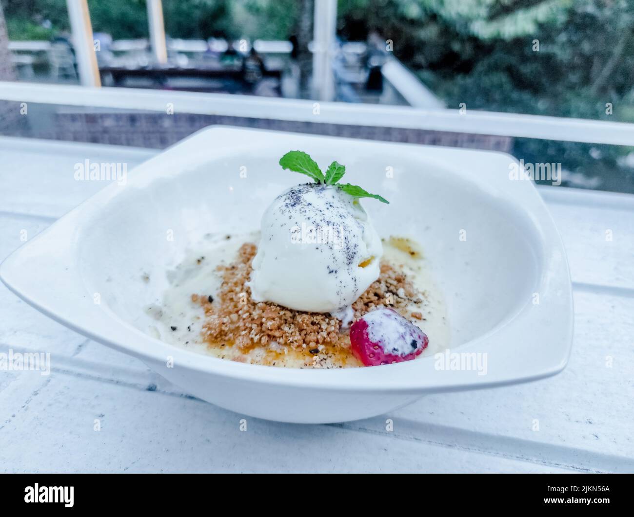 A closeup of a Durian ice cream with strawberry on white table Stock Photo