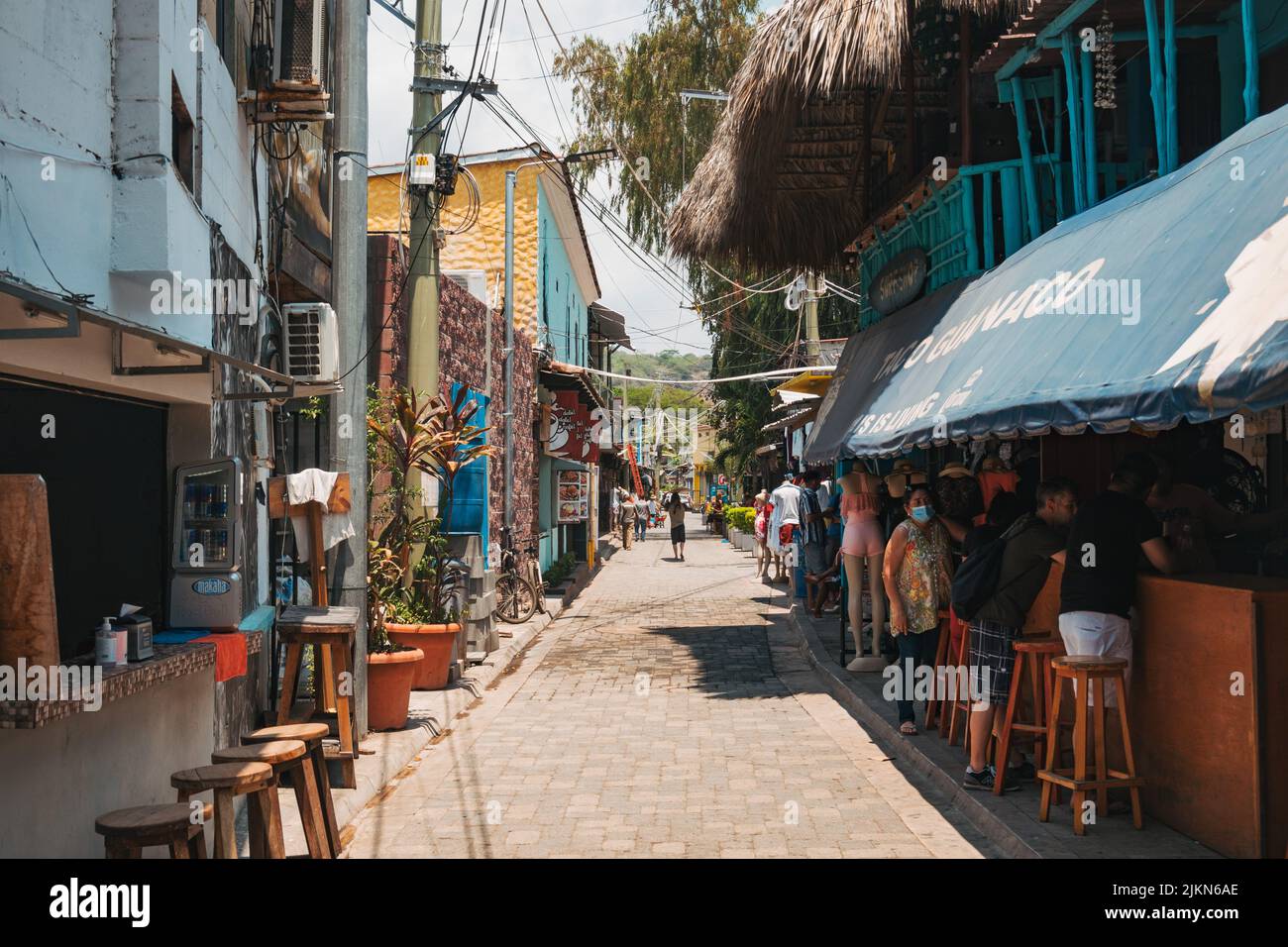 a narrow street with shops, restaurants and bars in El Tunco, El Salvador Stock Photo