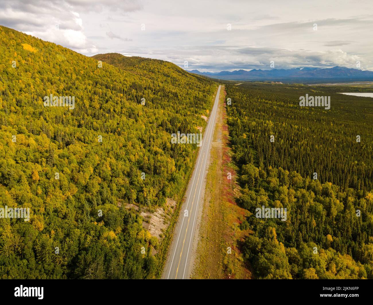 An aerial view of the Glenn Highway through lush greenery in Alaska