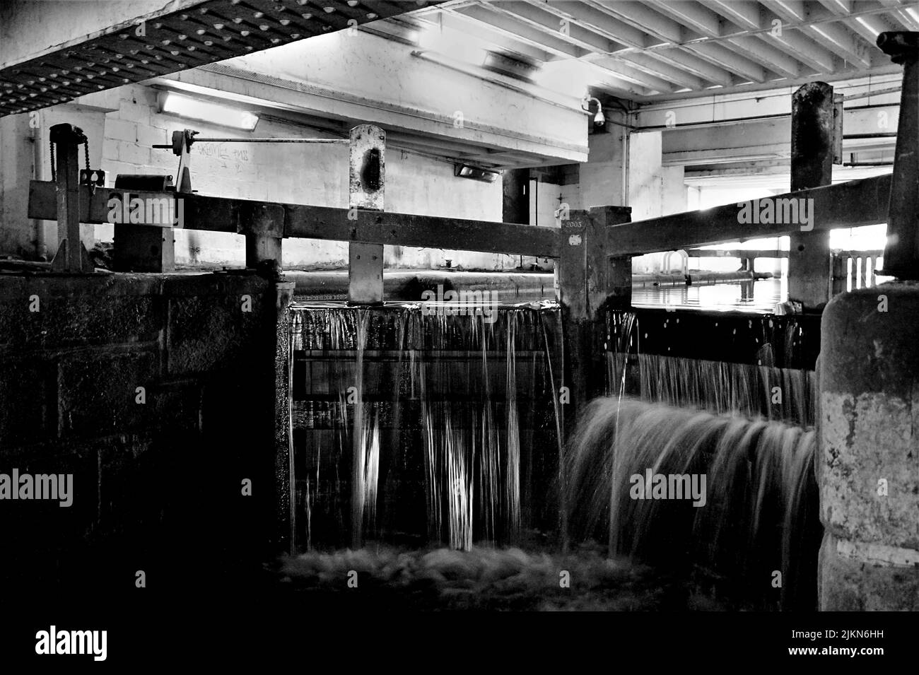 A grayscale shot of  basin locks canal underground, Manchester, UK Stock Photo