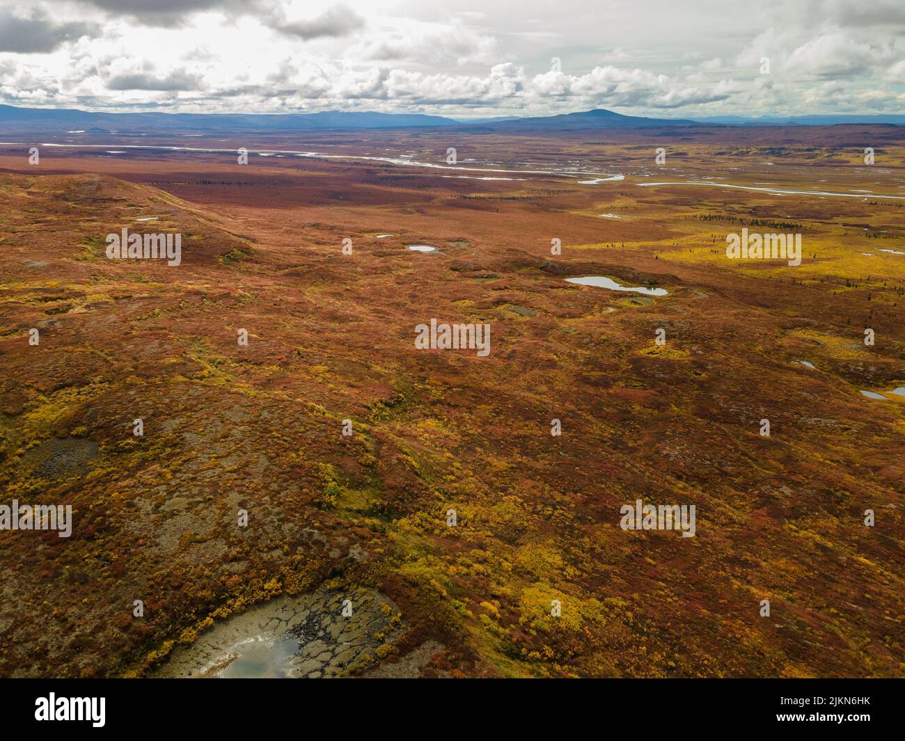 An aerial view of small lakes with Alaska Range in autumn colors in the background, Alaska, USA Stock Photo