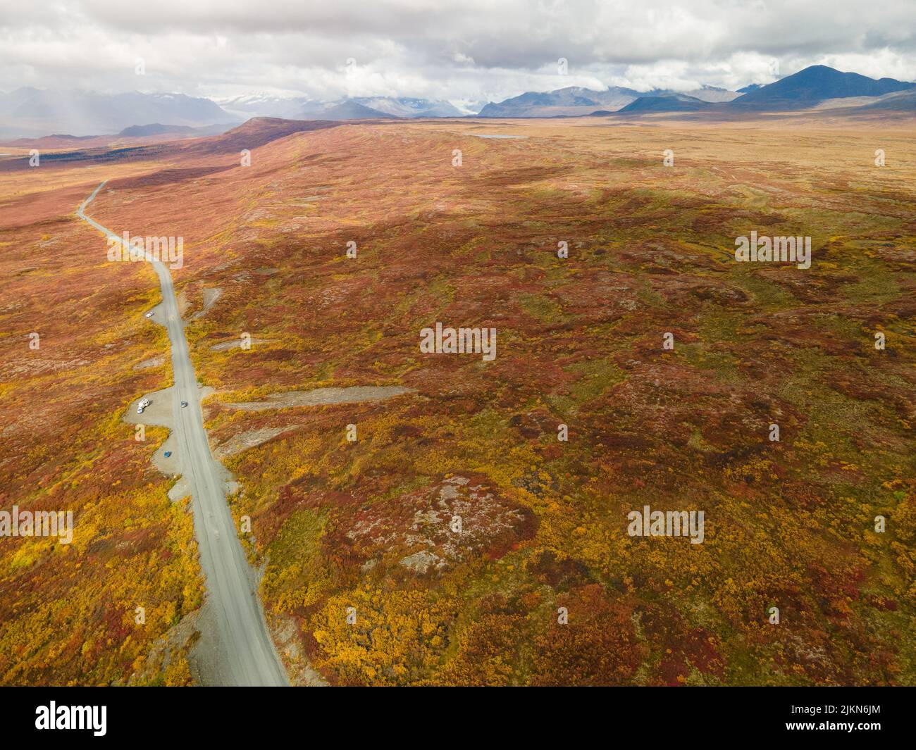 An aerial view of the Denali Highway with Alaska Range in autumn colors in the background, Alaska, USA Stock Photo