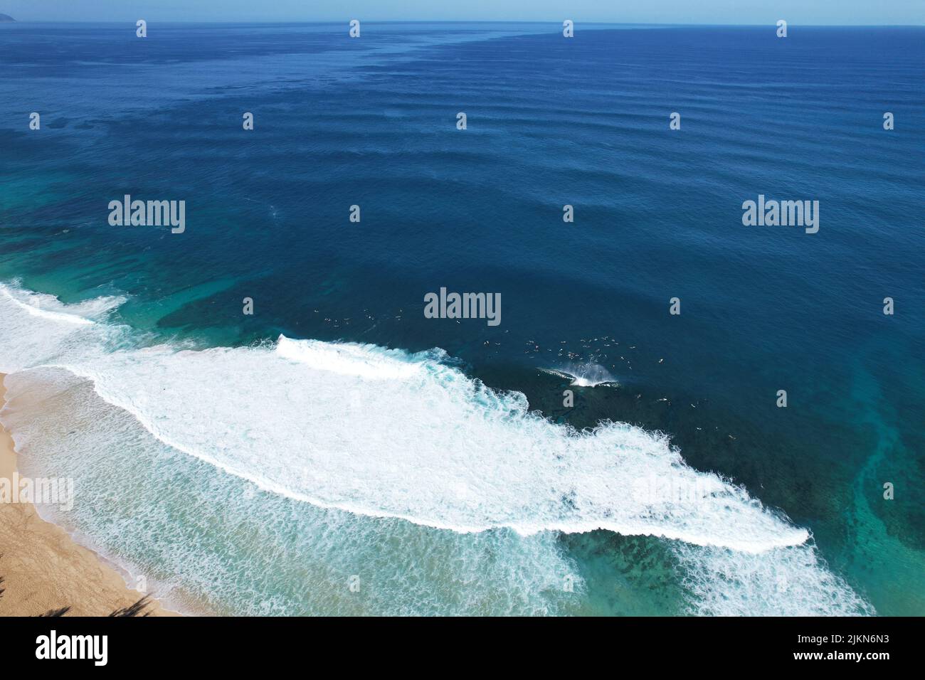 An aerial view of stormy blue waves with foam on a shore Stock Photo ...