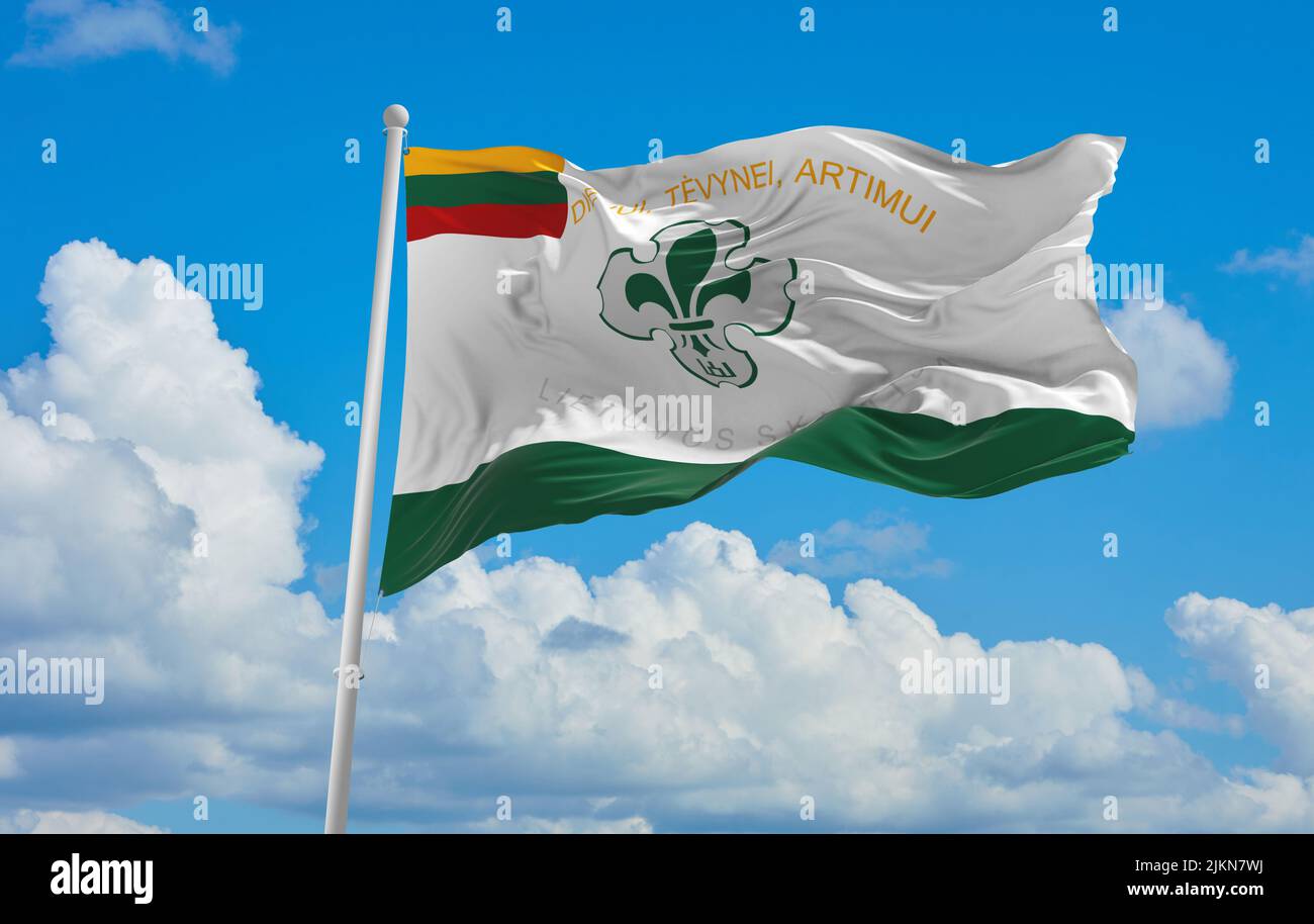 official flag of Scout lithuania at cloudy sky background on sunset, panoramic view. lithuanian travel and patriot concept. copy space for wide banner Stock Photo