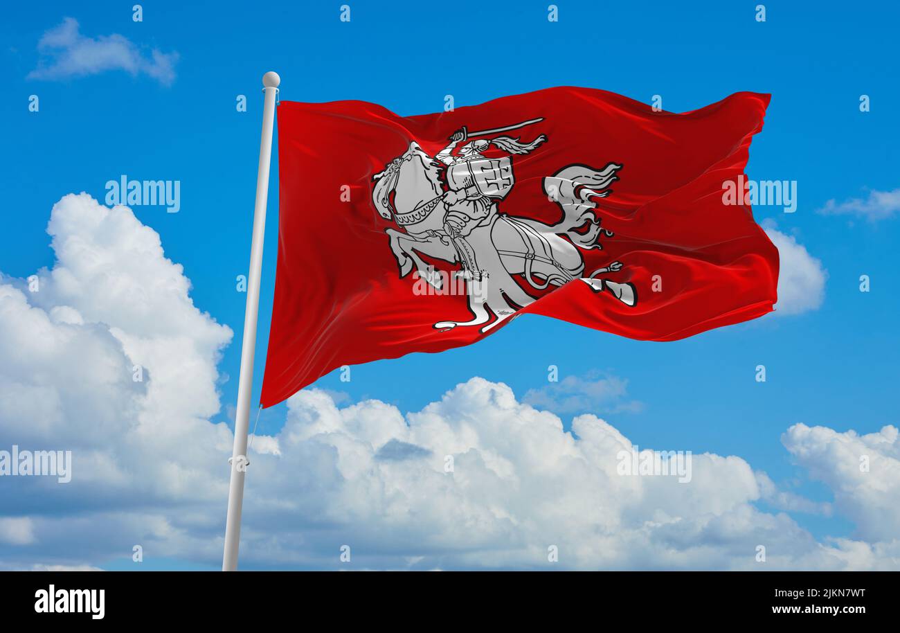 official flag of Republic 1920s lithuania at cloudy sky background on sunset, panoramic view. lithuanian travel and patriot concept. copy space for wi Stock Photo