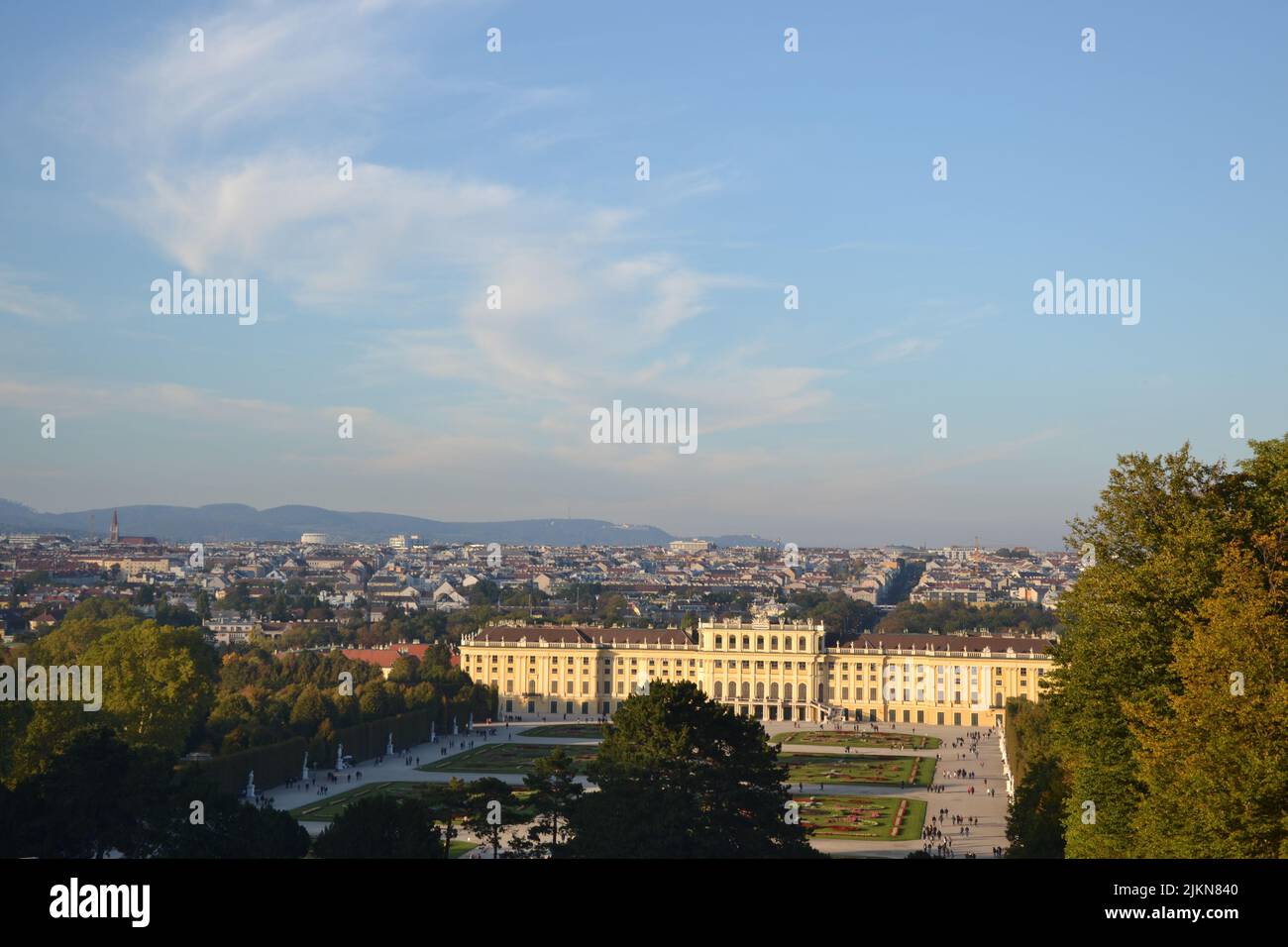 A high angle shot of Schloss Schonbrunn, over a background of the buildings of Vienna, Austria Stock Photo